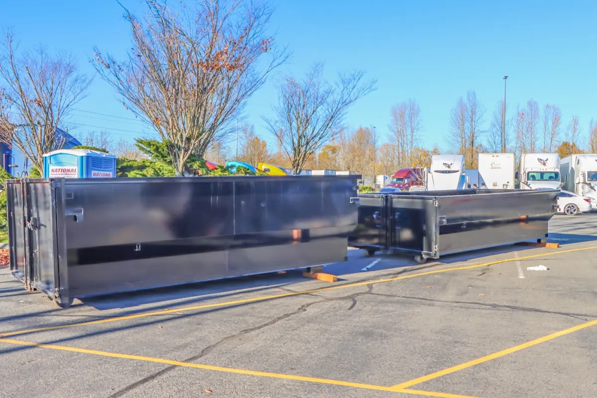 Professional dumpster rental service with roll-off container on residential driveway in White